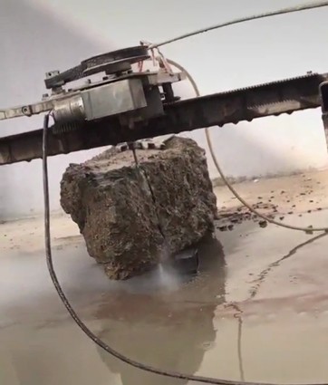 portable waterjet cuts a block of concrete